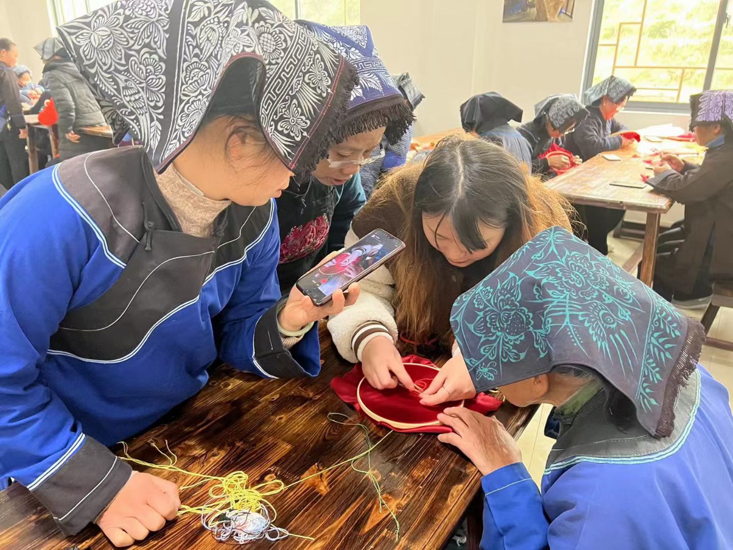 A designer's desk with sketches, fabric swatches, and a prototype doll